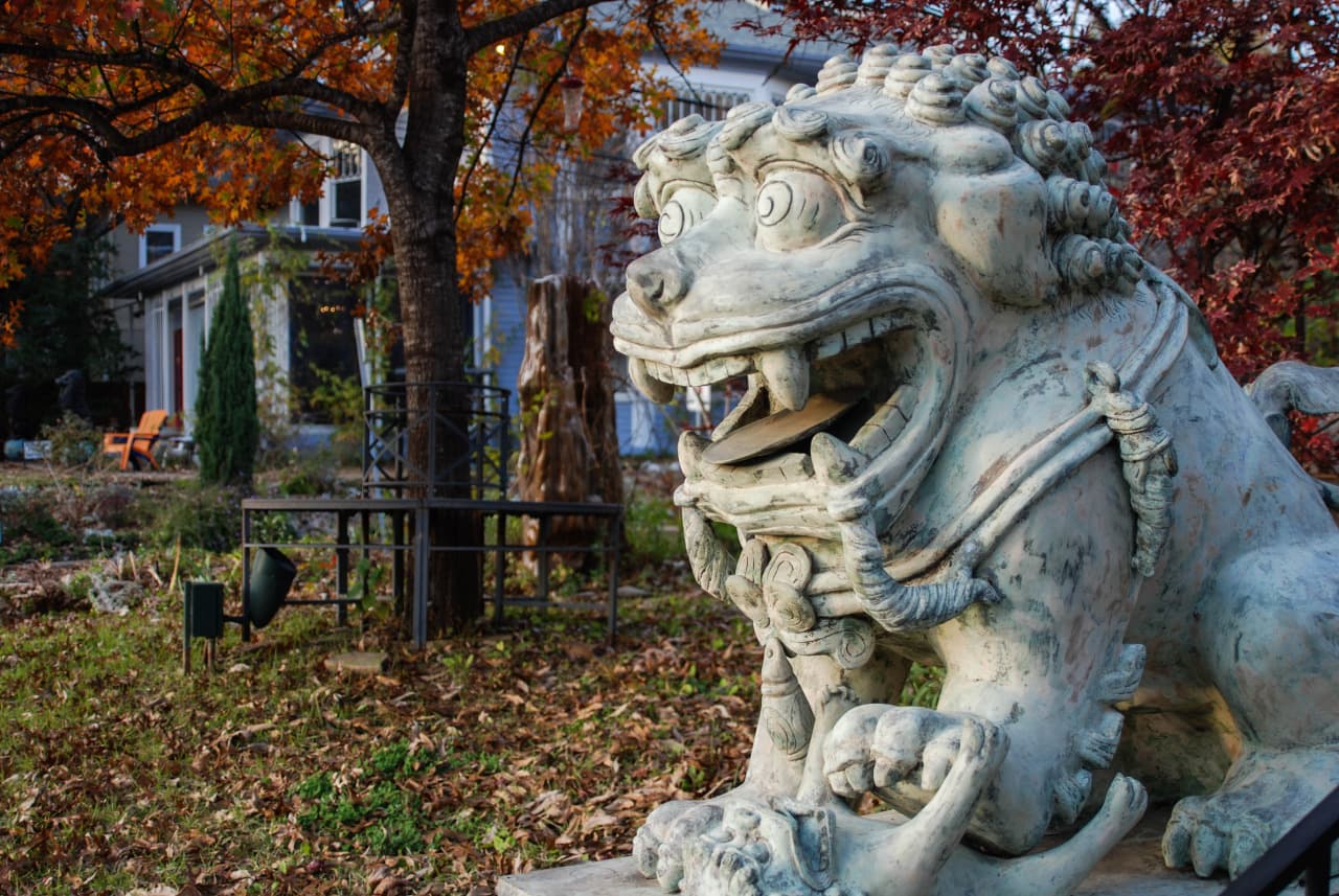 Stone lion statue in Dragon Park at Select Salon Dallas